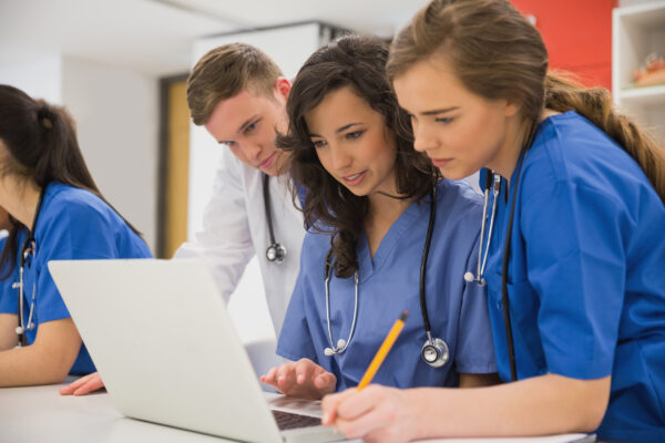 Image of Doctors and Nurses looking at computer