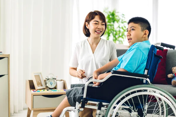 Image of carer with boy in wheelchair