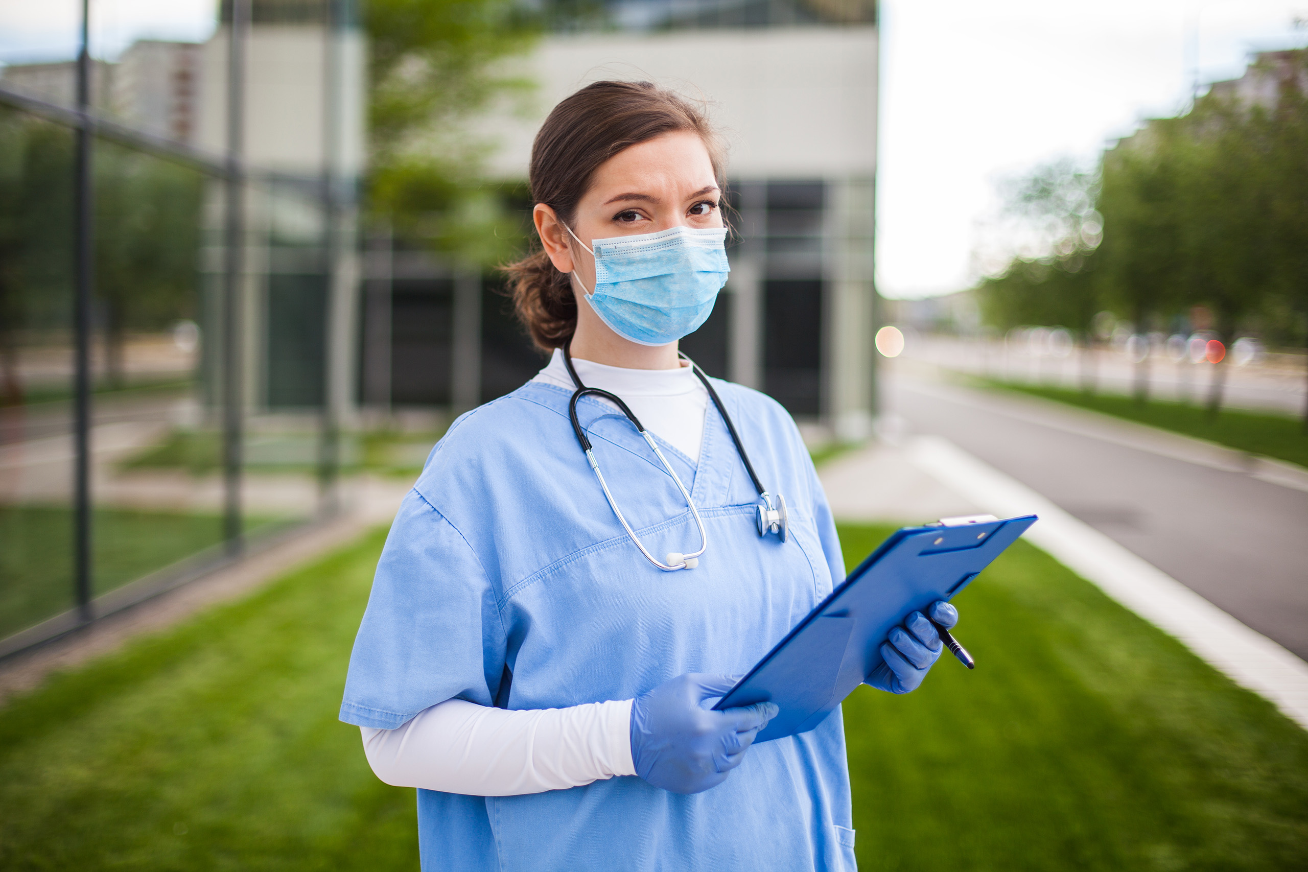 Image of Nurse in face mask holding documents