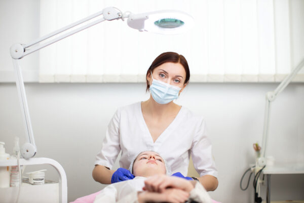 Image of Dentist with face mask treating patient